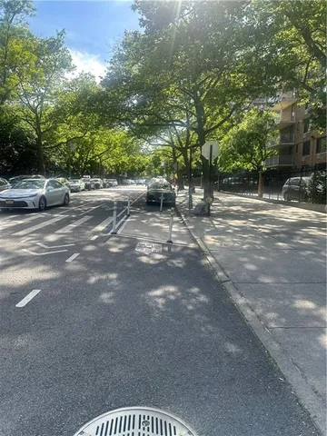 a view of street with tall trees