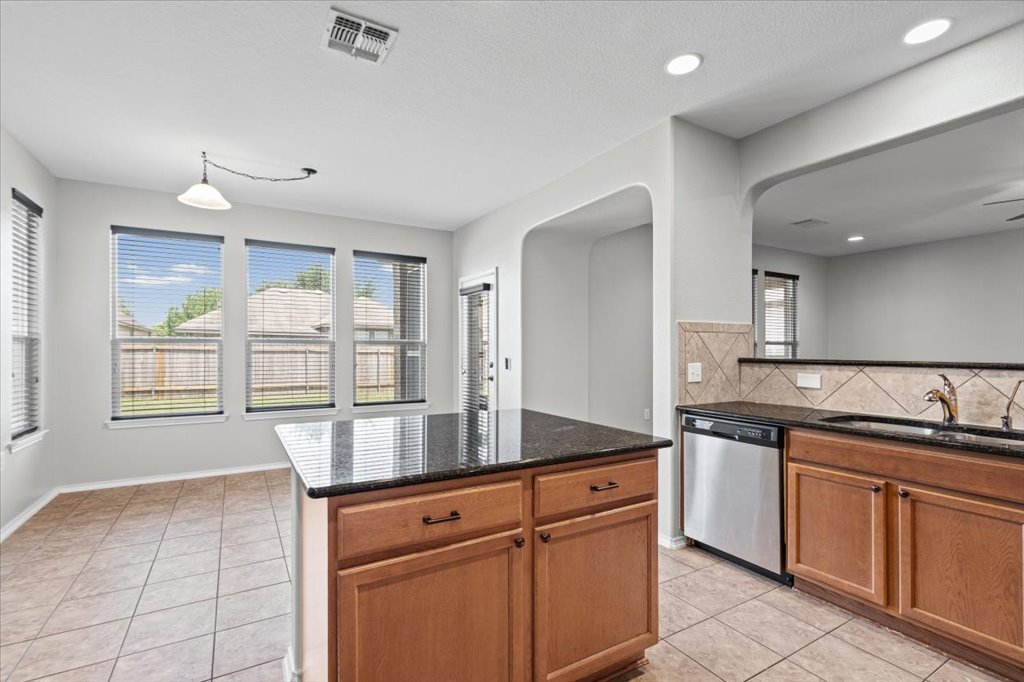 8804 Capitol View Drive Austin, TX 78747 - Photo 13 of 32 a kitchen with granite countertop a sink and cabinets