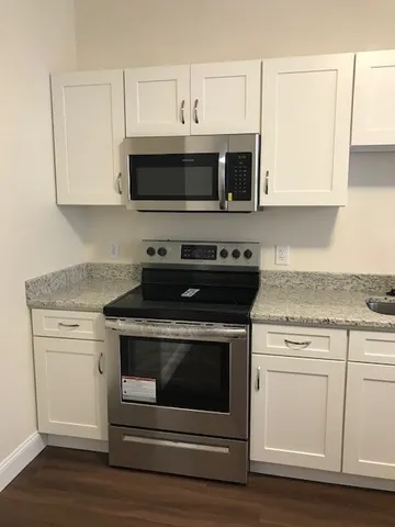 a stove top oven sitting inside of a kitchen
