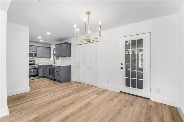 a view of kitchen with granite countertop cabinets and refrigerator