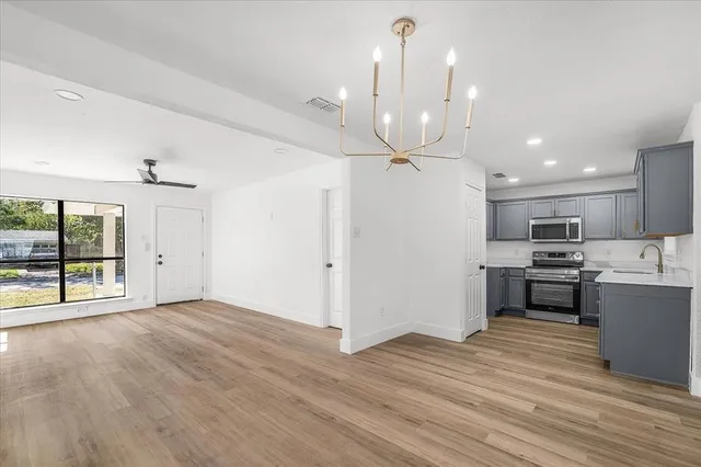 a view of kitchen with cabinets and wooden floor