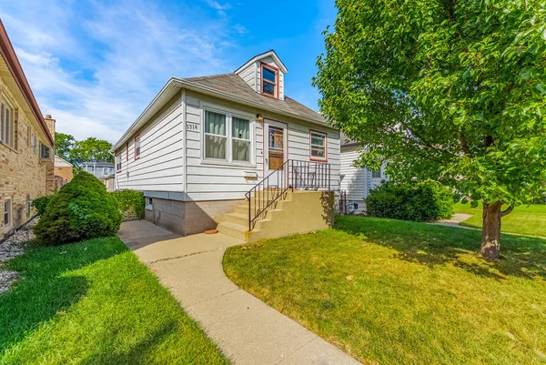 a front view of a house with yard patio and green space