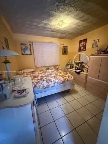 a bedroom with bed and window