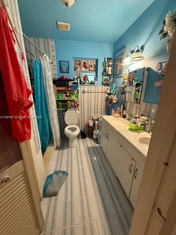 a view of a living room with furniture and wooden floor