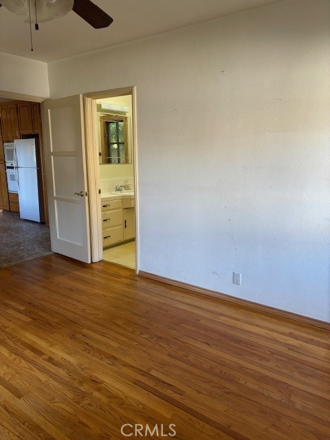 6314 Friends Avenue Whittier, CA 90601 - Photo 8 of 12 an empty room with wooden floor and closet