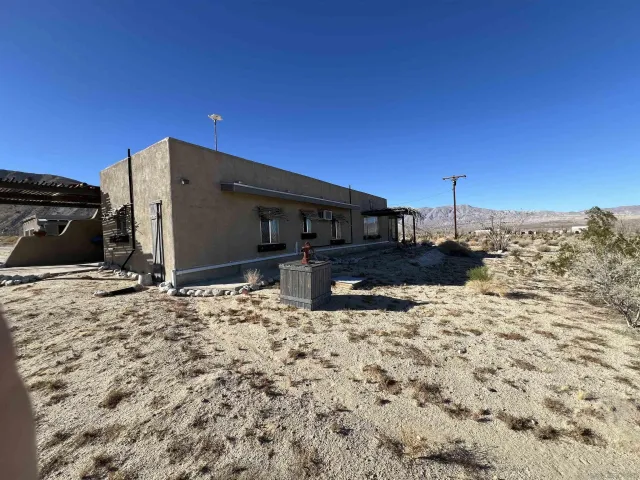 a view of a house with snow on the road