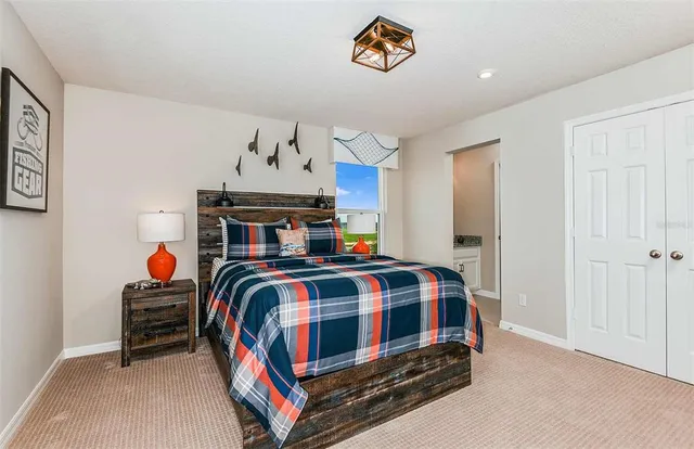 a bedroom with a bed and a chandelier