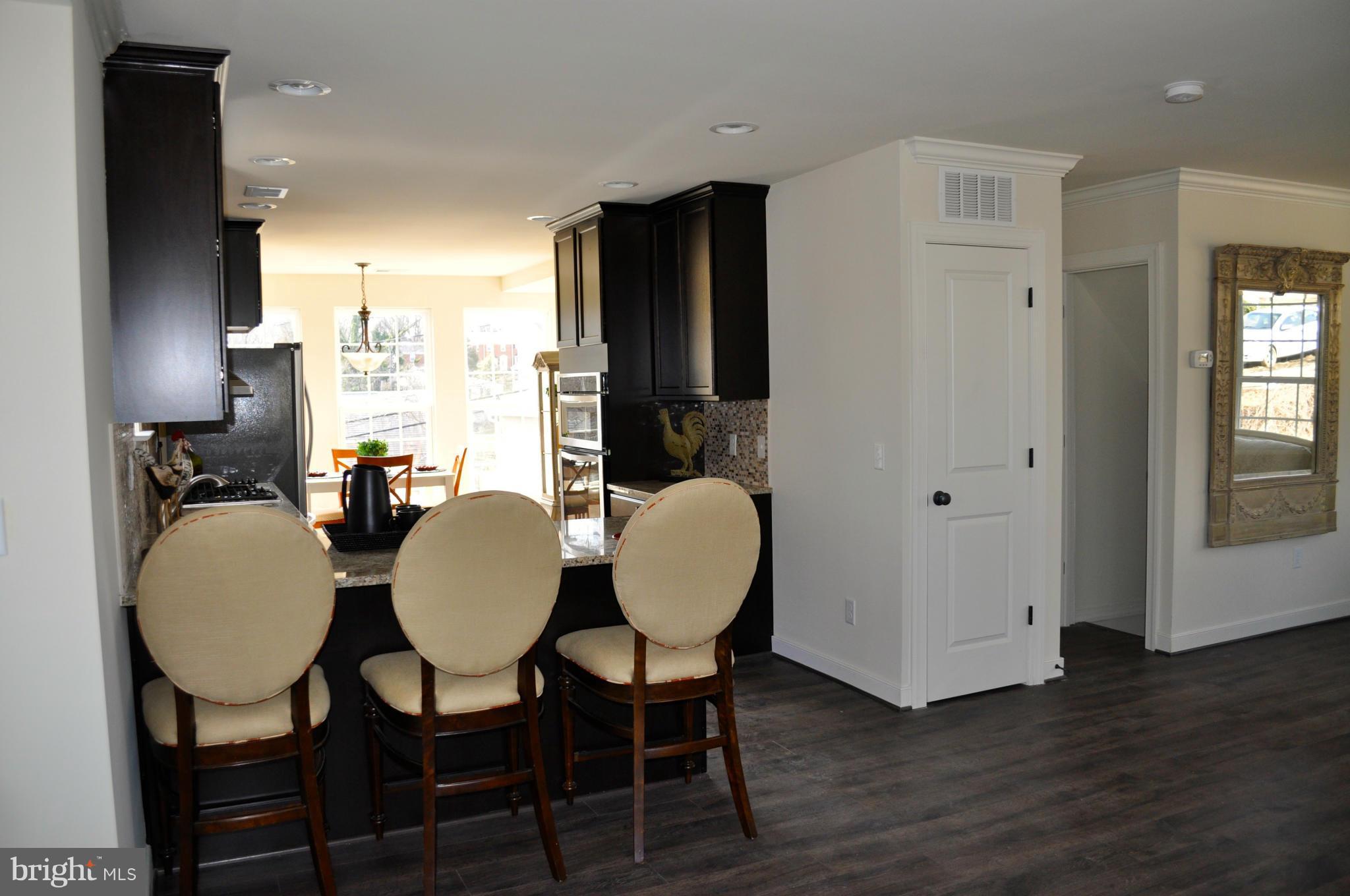 1011 Overbrook Road Baltimore, MD 21239 - Photo 14 of 24 a view of a dining room with furniture and wooden floor