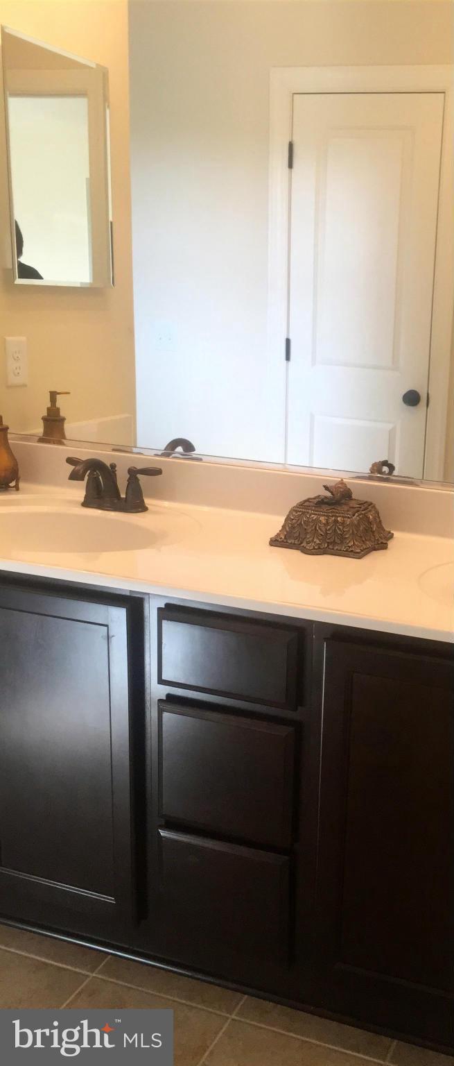 1011 Overbrook Road Baltimore, MD 21239 - Photo 20 of 24 a bathroom with a sink and a mirror