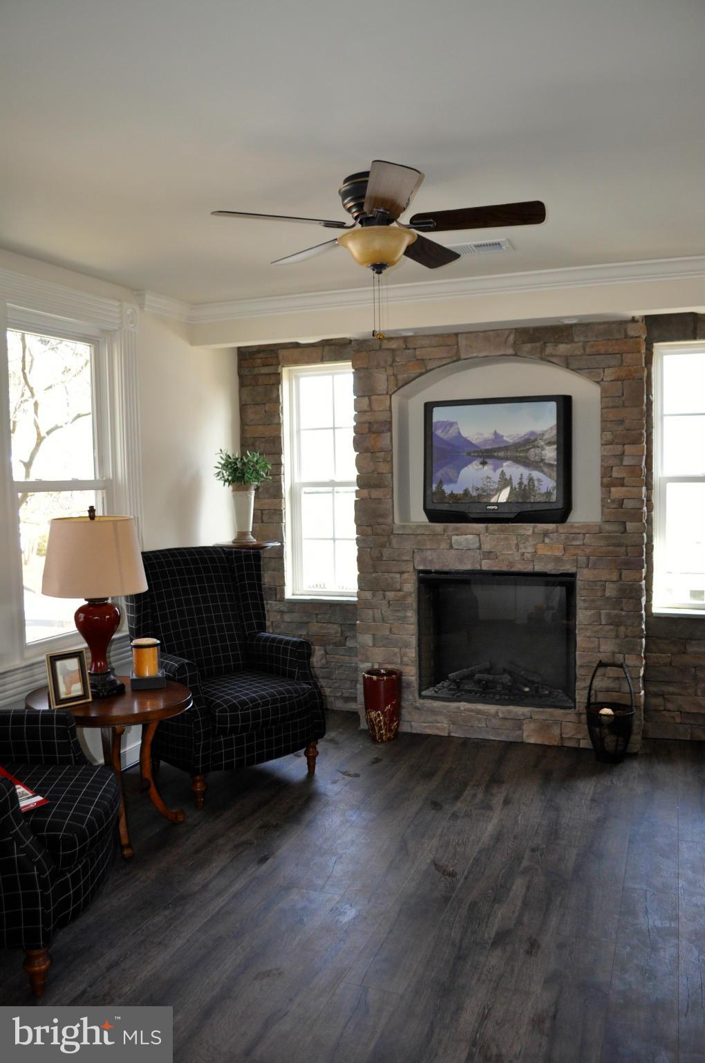 1011 Overbrook Road Baltimore, MD 21239 - Photo 6 of 24 a living room with furniture and a fireplace