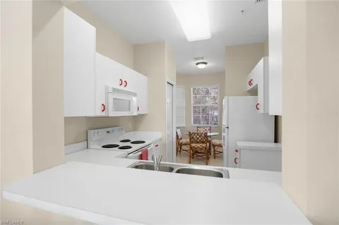 a kitchen that has a sink and a stove