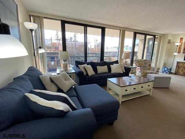 a living room with furniture and large windows