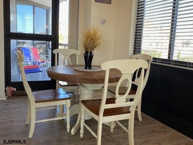 a view of a dining room with furniture and window