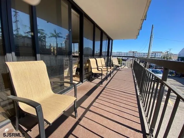 a view of a balcony with chairs