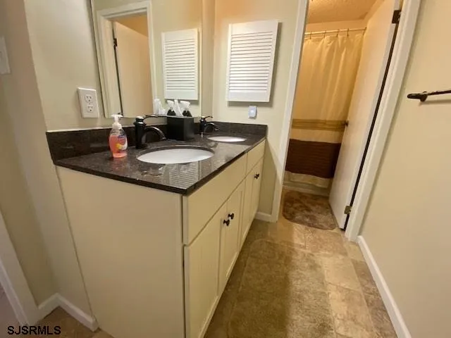 a bathroom with sink double vanity and mirror