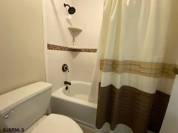 a bathroom with a bathtub and shower