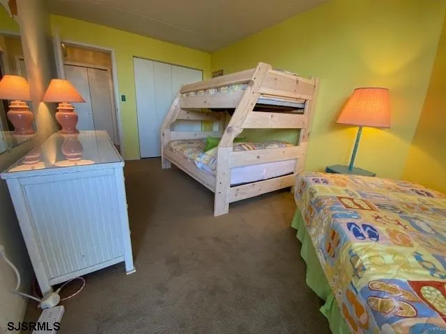 a bedroom with a bed and a lamp