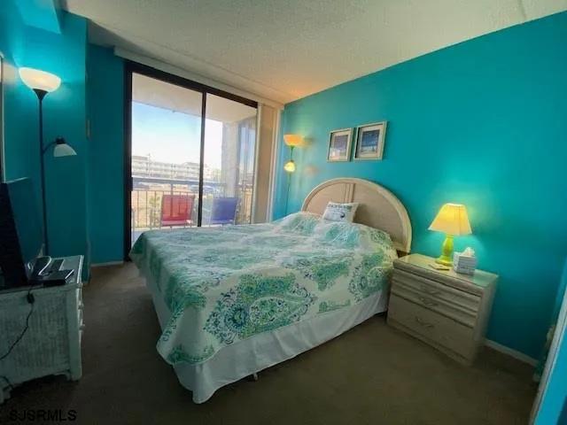 a bedroom with a bed chair and window