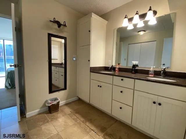 a bathroom with a double vanity sink and a mirror