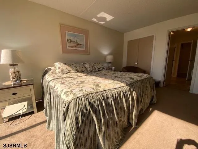 a bed sitting in a bedroom next to a lamp