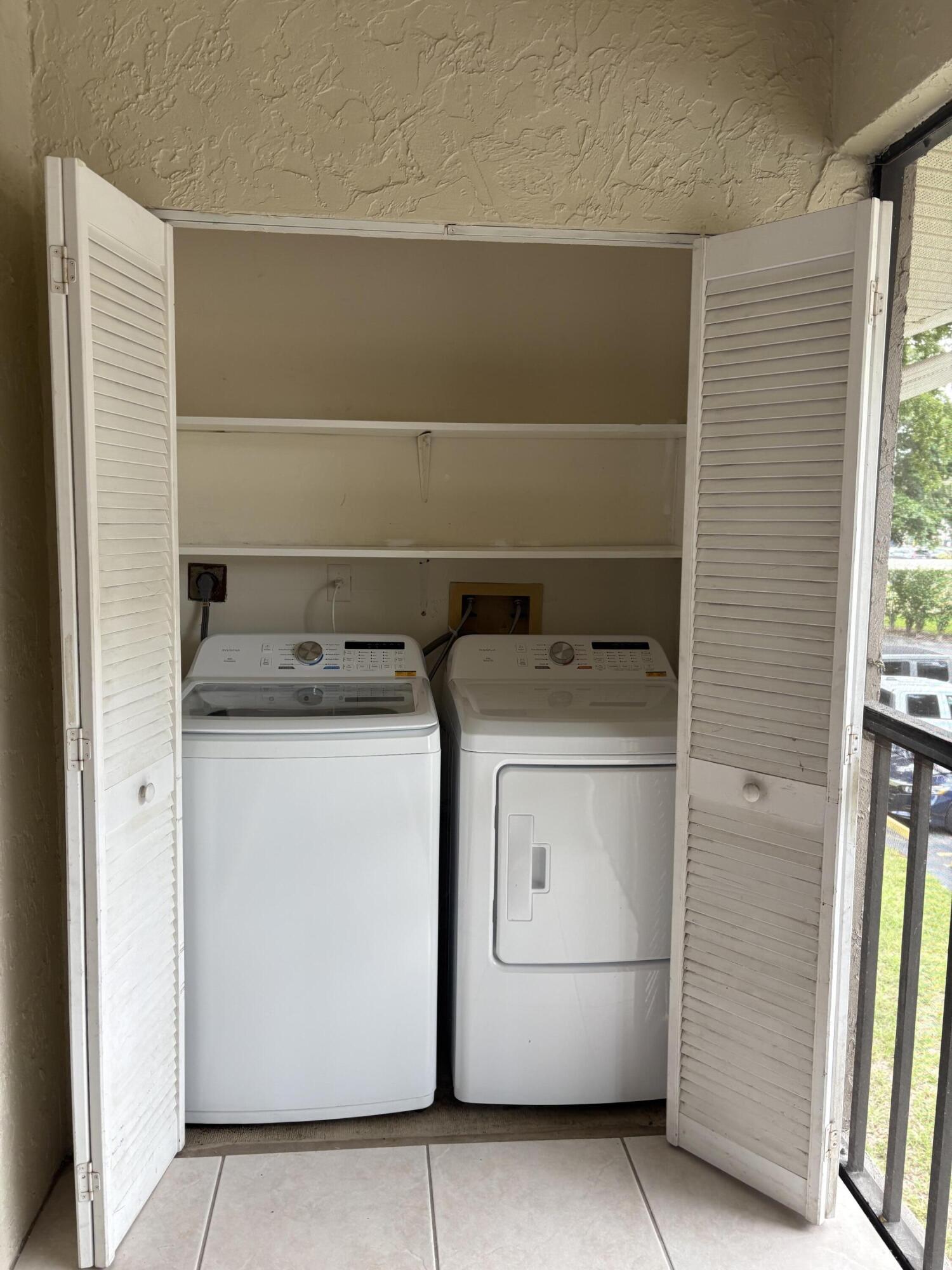 9845 Pineapple Tree Drive, Unit 208 Boynton Beach, FL 33436 - Photo 13 of 21 a utility room with dryer and washer