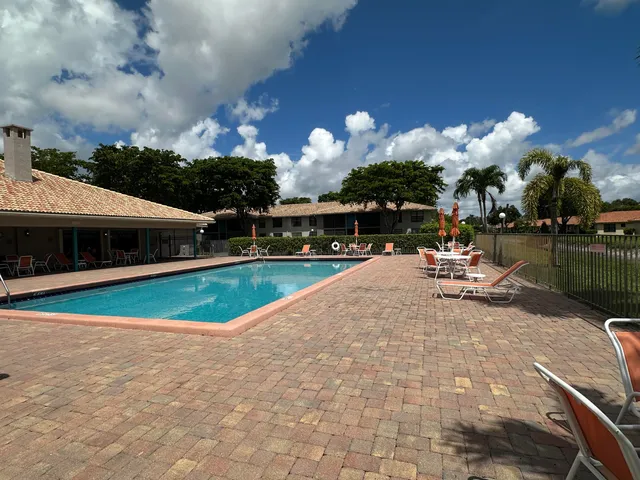 a view of a house with swimming pool and sitting area