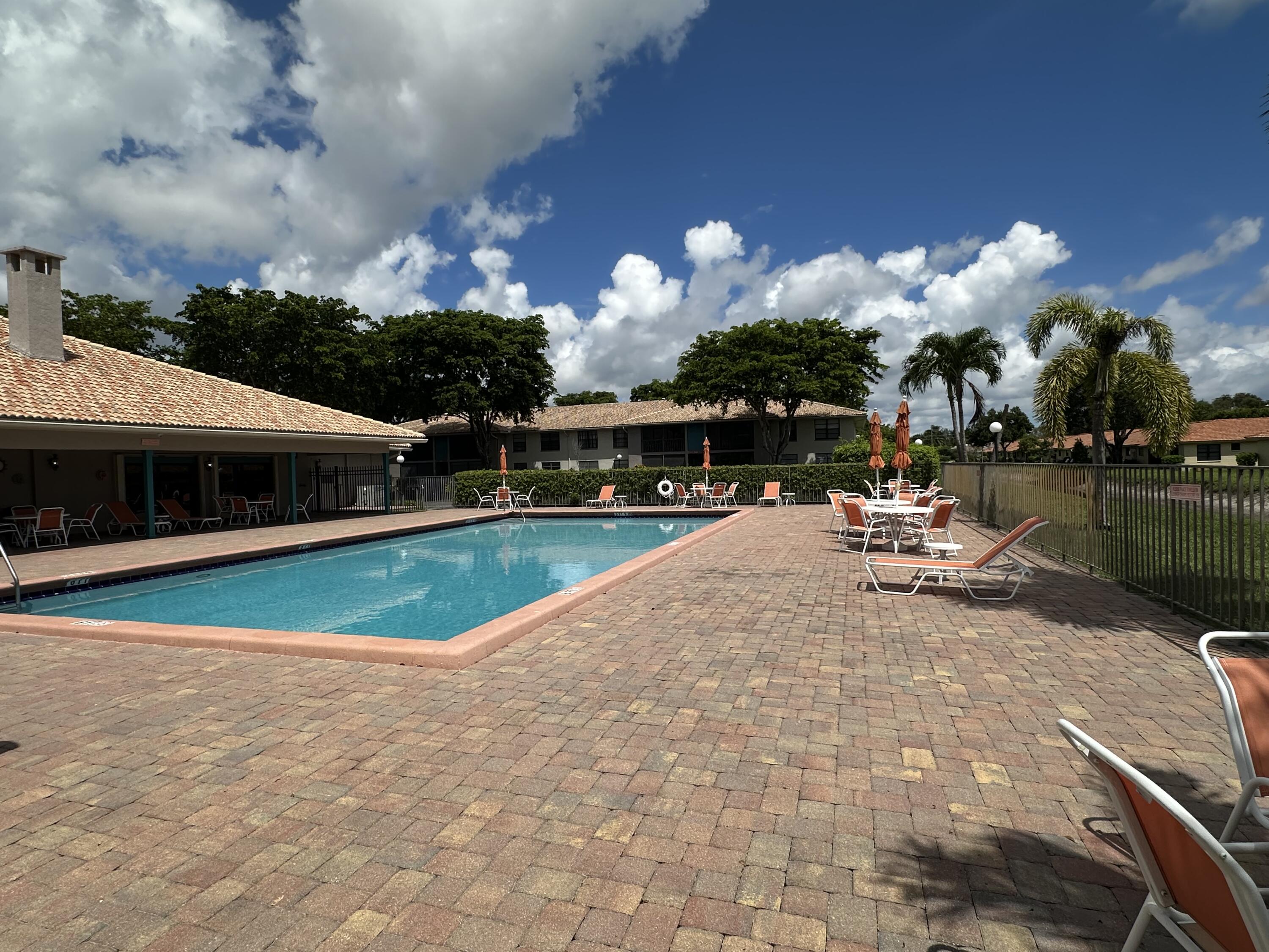 9845 Pineapple Tree Drive, Unit 208 Boynton Beach, FL 33436 - Photo 18 of 21 a view of a lake with a building in the background