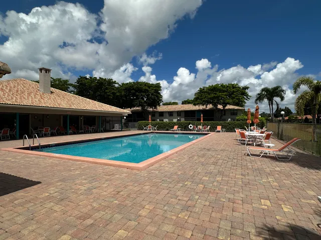 a view of a table and chairs in backyard of the house