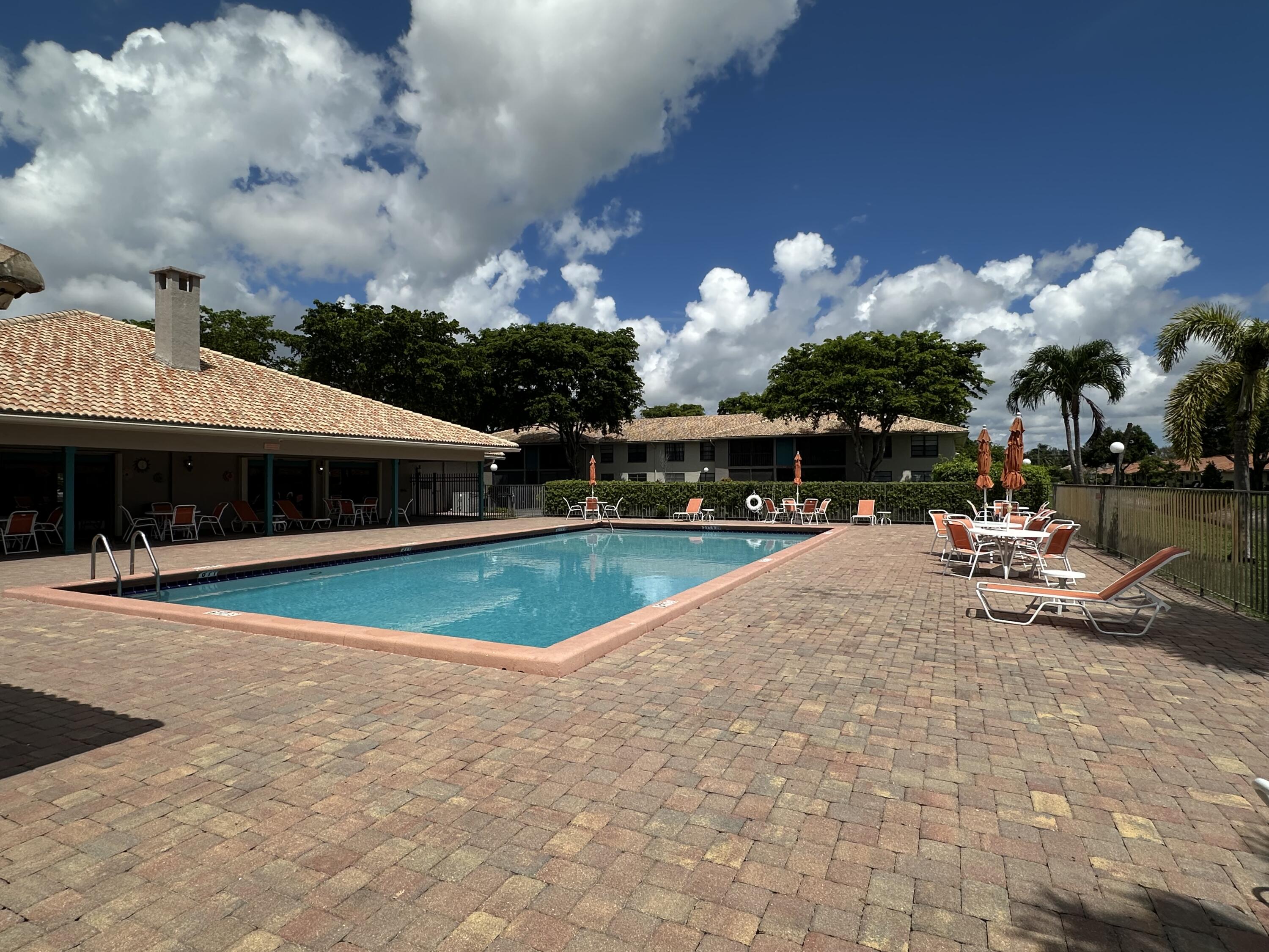 9845 Pineapple Tree Drive, Unit 208 Boynton Beach, FL 33436 - Photo 19 of 21 a view of a house with swimming pool and sitting area