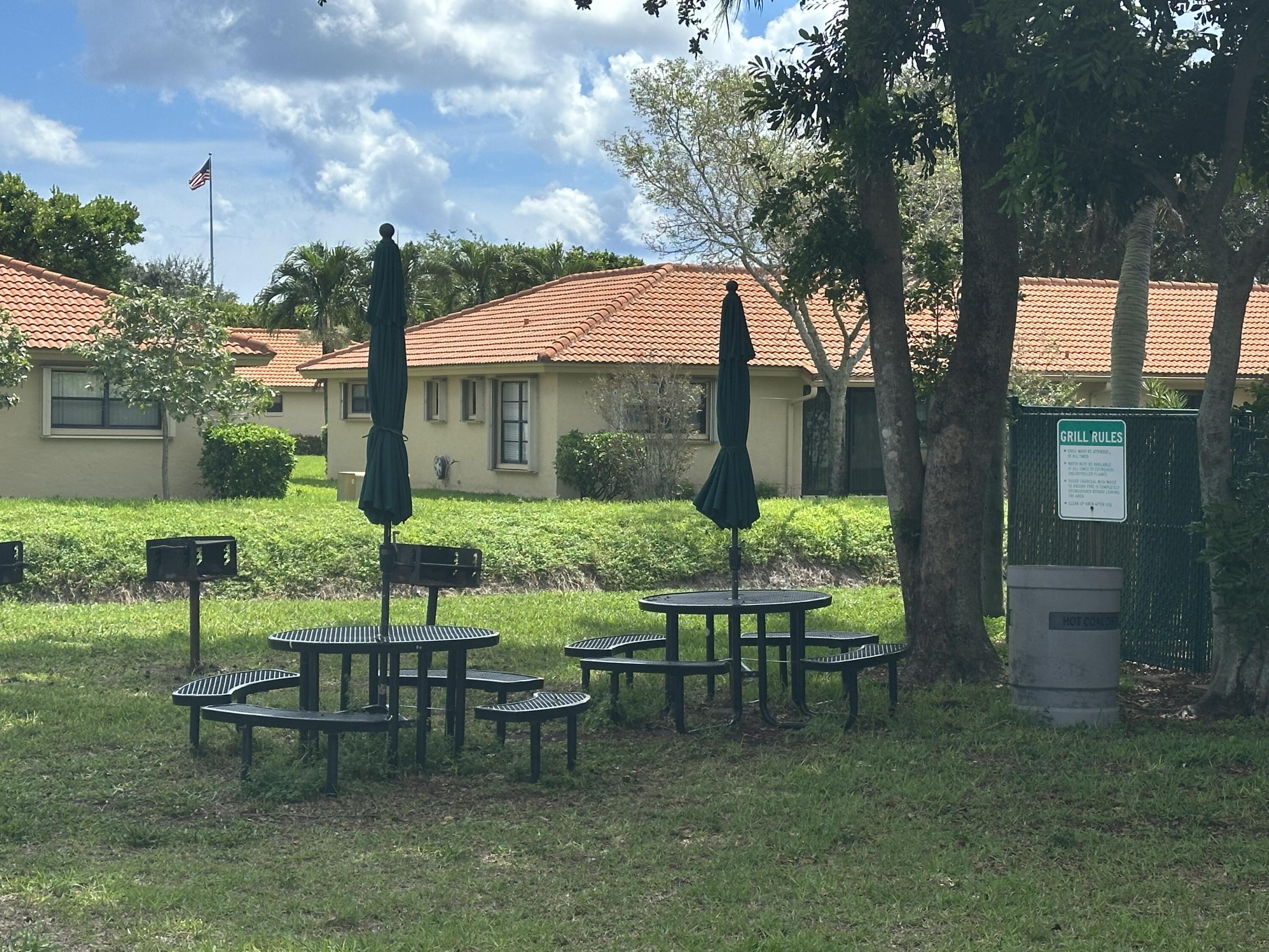 9845 Pineapple Tree Drive, Unit 208 Boynton Beach, FL 33436 - Photo 20 of 21 a view of a table and chairs in backyard of the house