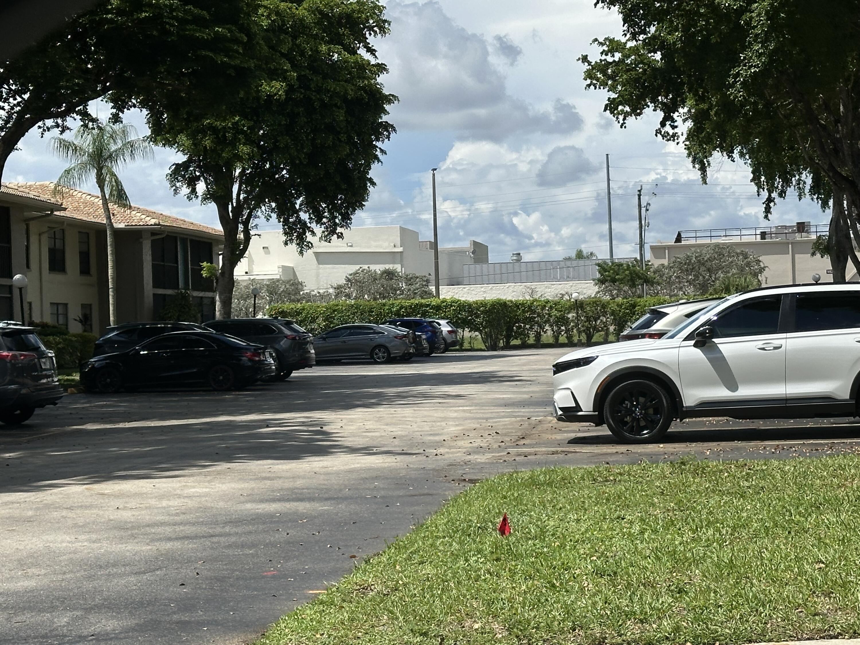9845 Pineapple Tree Drive, Unit 208 Boynton Beach, FL 33436 - Photo 21 of 21 a view of street with parked cars