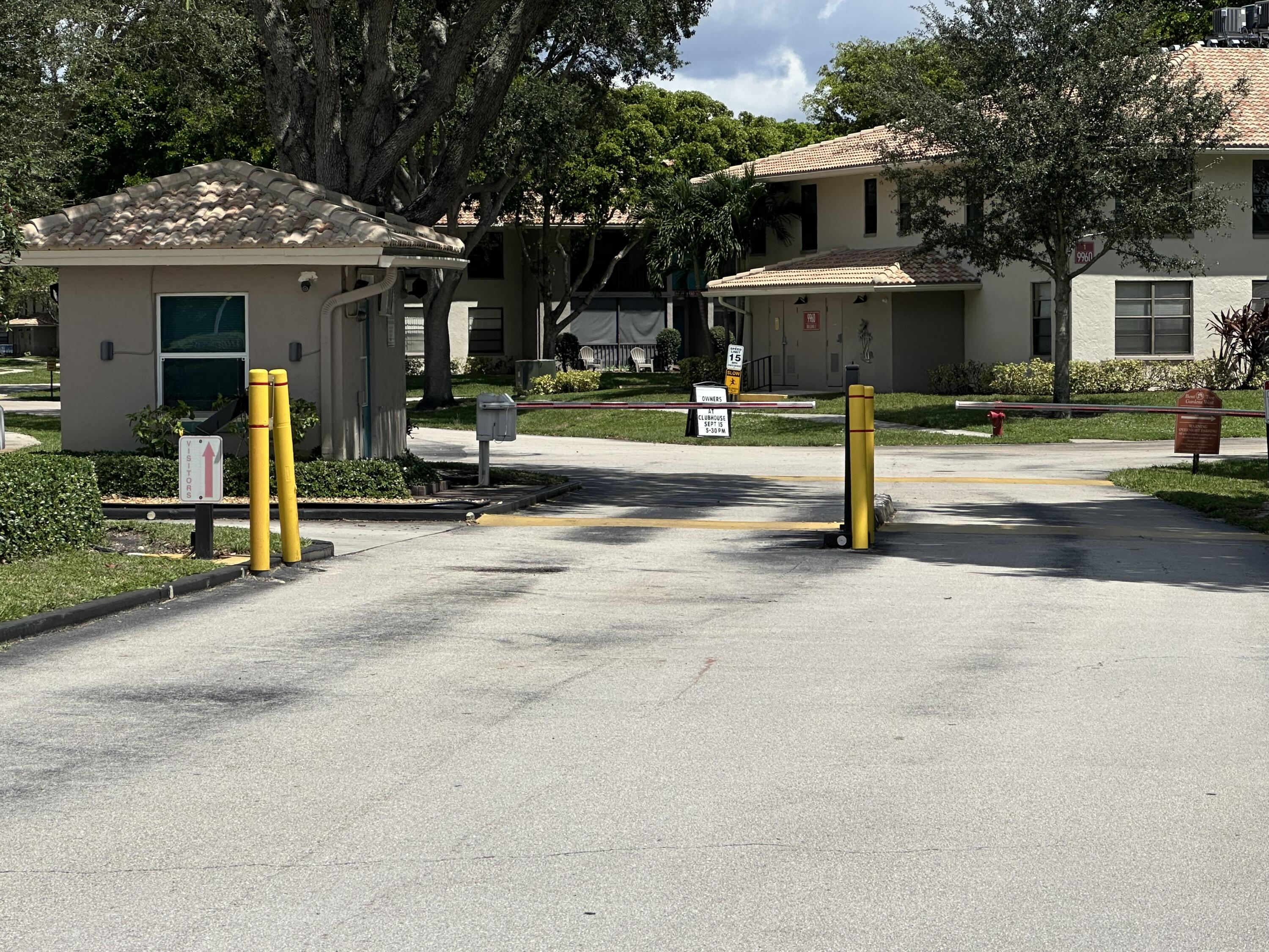 9845 Pineapple Tree Drive, Unit 208 Boynton Beach, FL 33436 - Photo 3 of 21 a view of a house with street and trees
