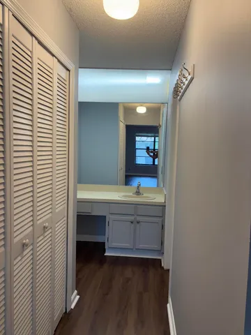 a bathroom with a granite countertop sink toilet and shower