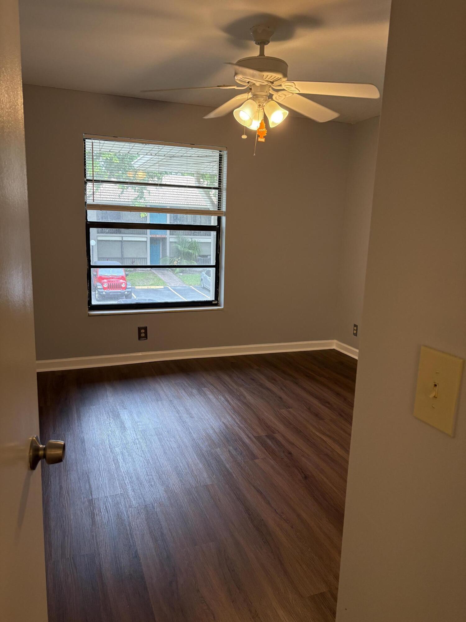 9845 Pineapple Tree Drive, Unit 208 Boynton Beach, FL 33436 - Photo 8 of 21 wooden floor in an empty room with a window