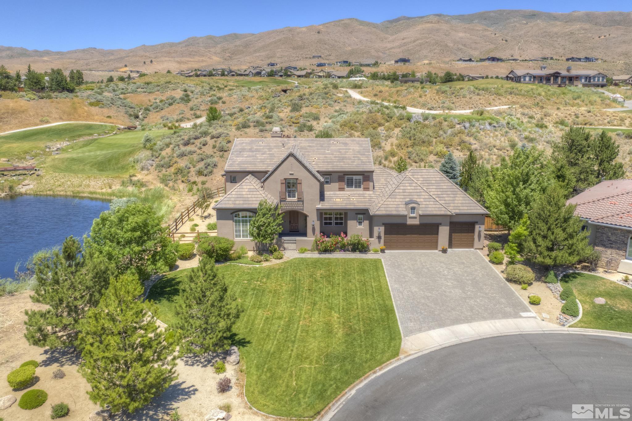 8490 Castlehawk Court Reno, NV 89523 - Photo 1 of 40 an aerial view of residential houses with outdoor space and river