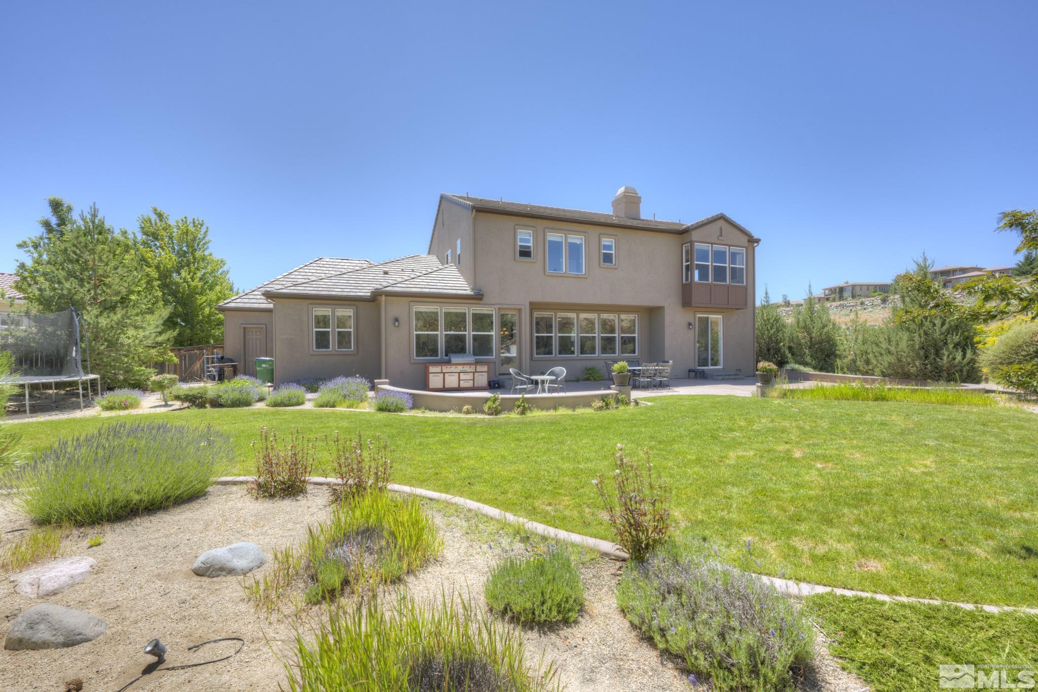 8490 Castlehawk Court Reno, NV 89523 - Photo 6 of 40 a front view of a house with garden
