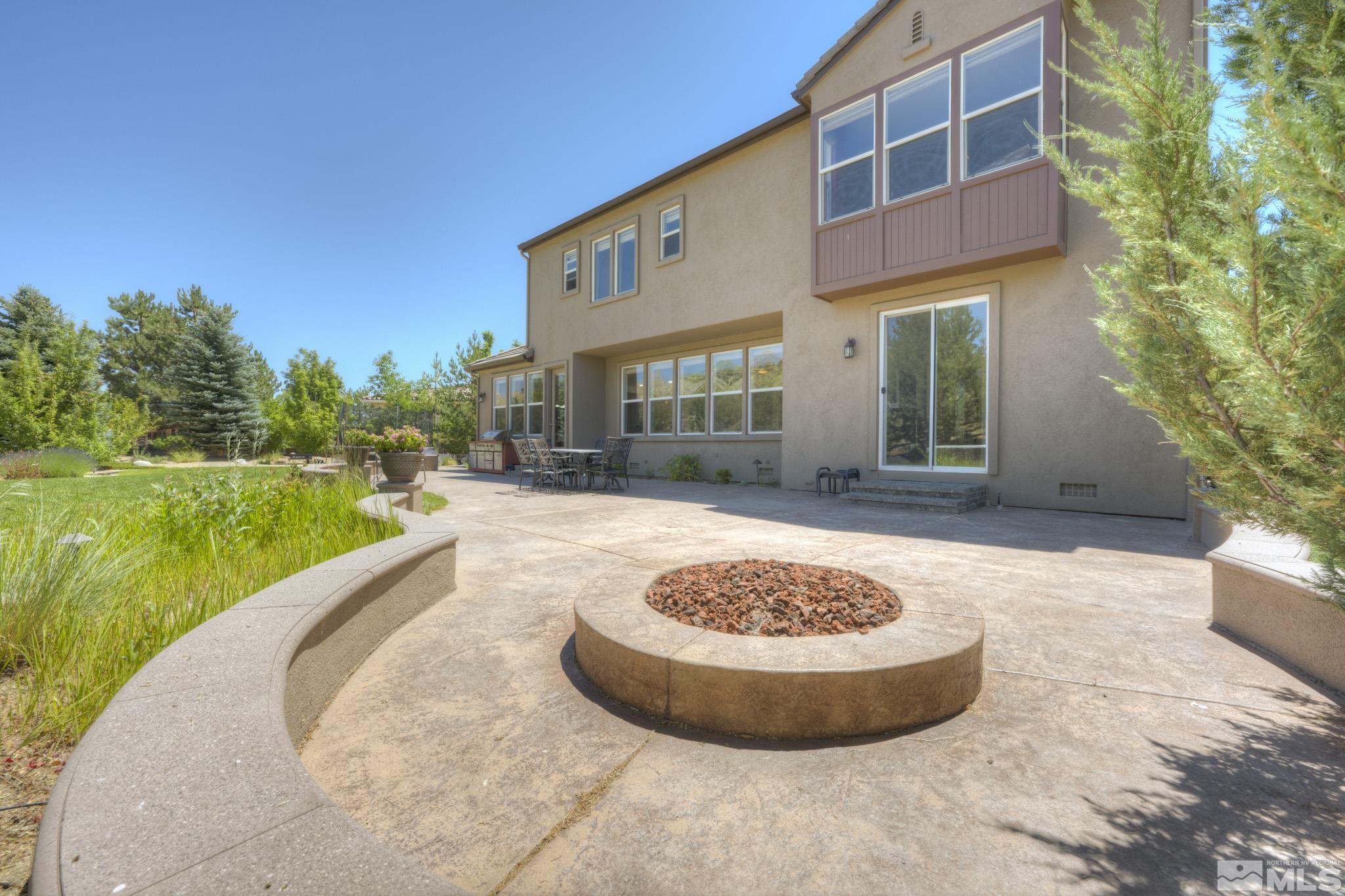 8490 Castlehawk Court Reno, NV 89523 - Photo 9 of 40 a view of a house with swimming pool and a yard