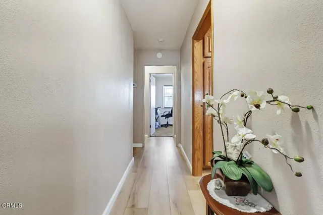 a bed sitting in a spacious bedroom next to a window