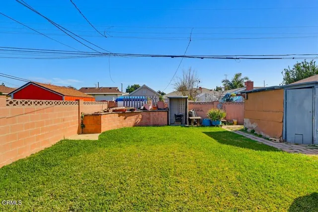 a view of a backyard with plants and a patio