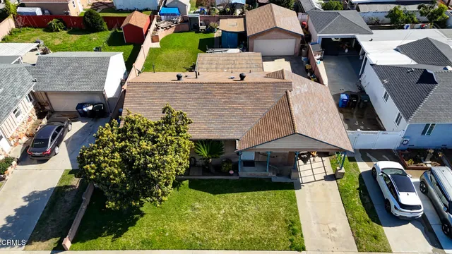 an aerial view of a house with yard