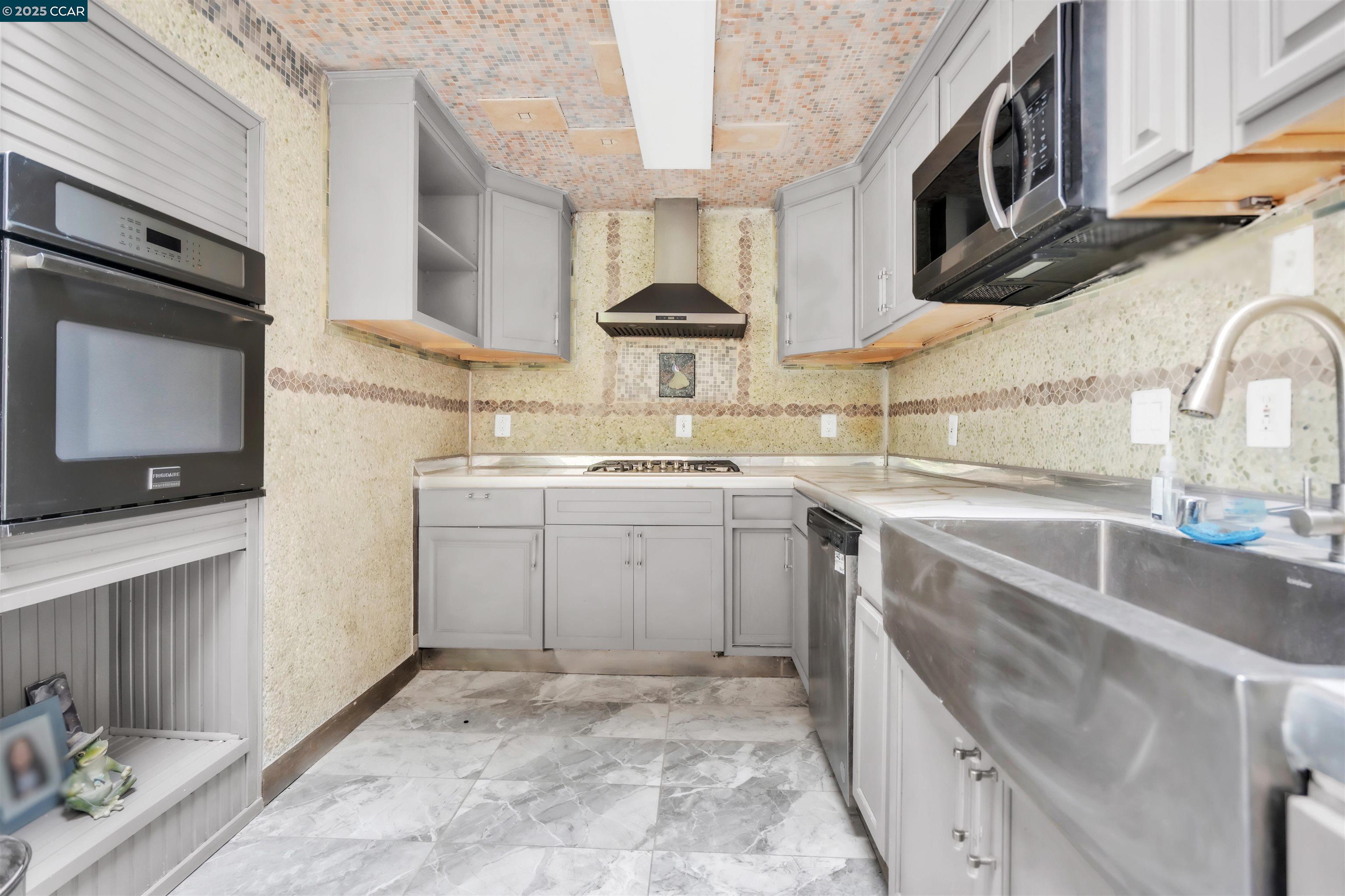 1544 Bailey Road, Unit 30 Concord, CA 94521 - Photo 5 of 20 a kitchen with a sink stove and cabinets