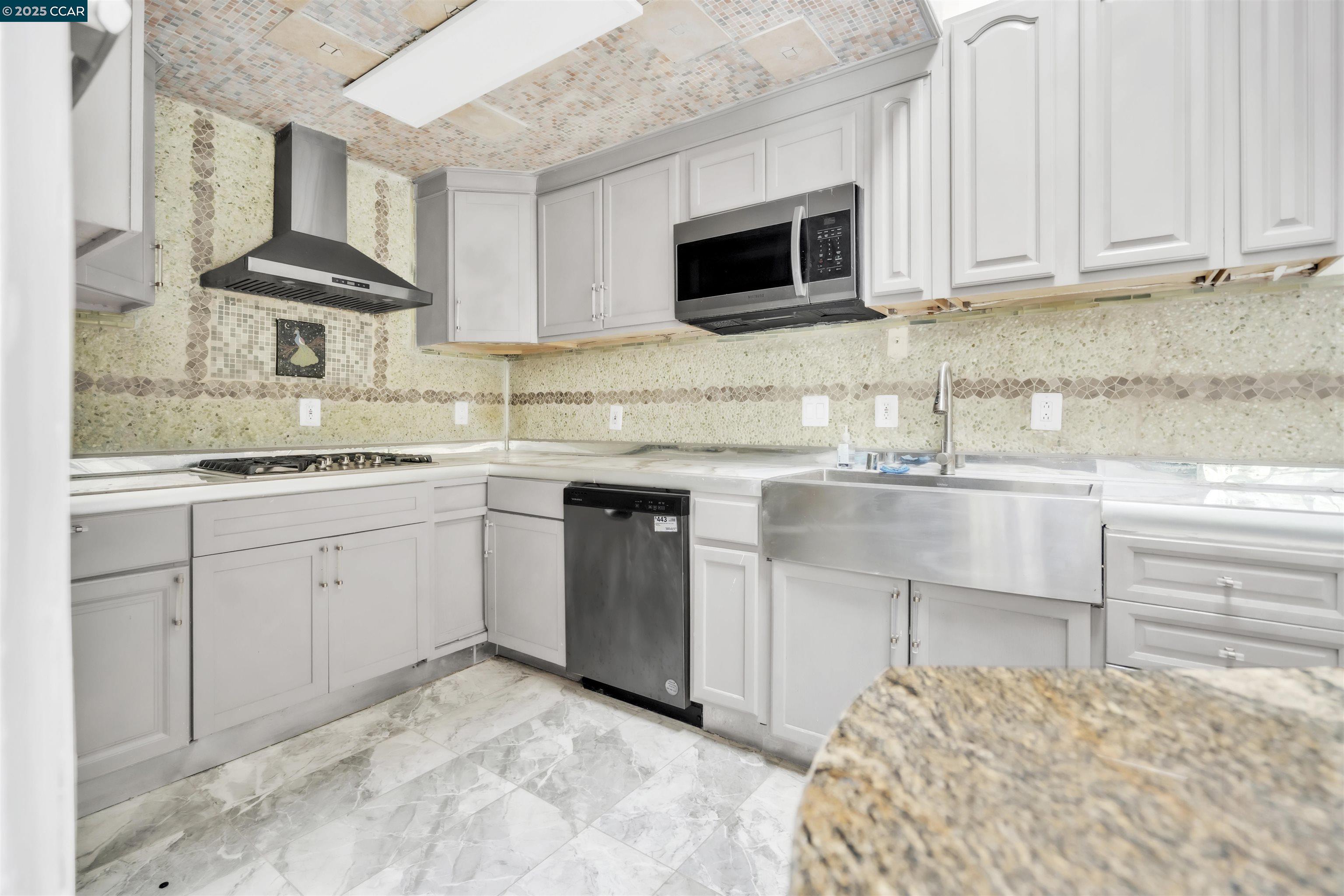 1544 Bailey Road, Unit 30 Concord, CA 94521 - Photo 6 of 20 a kitchen with white cabinets sink and stainless steel appliances