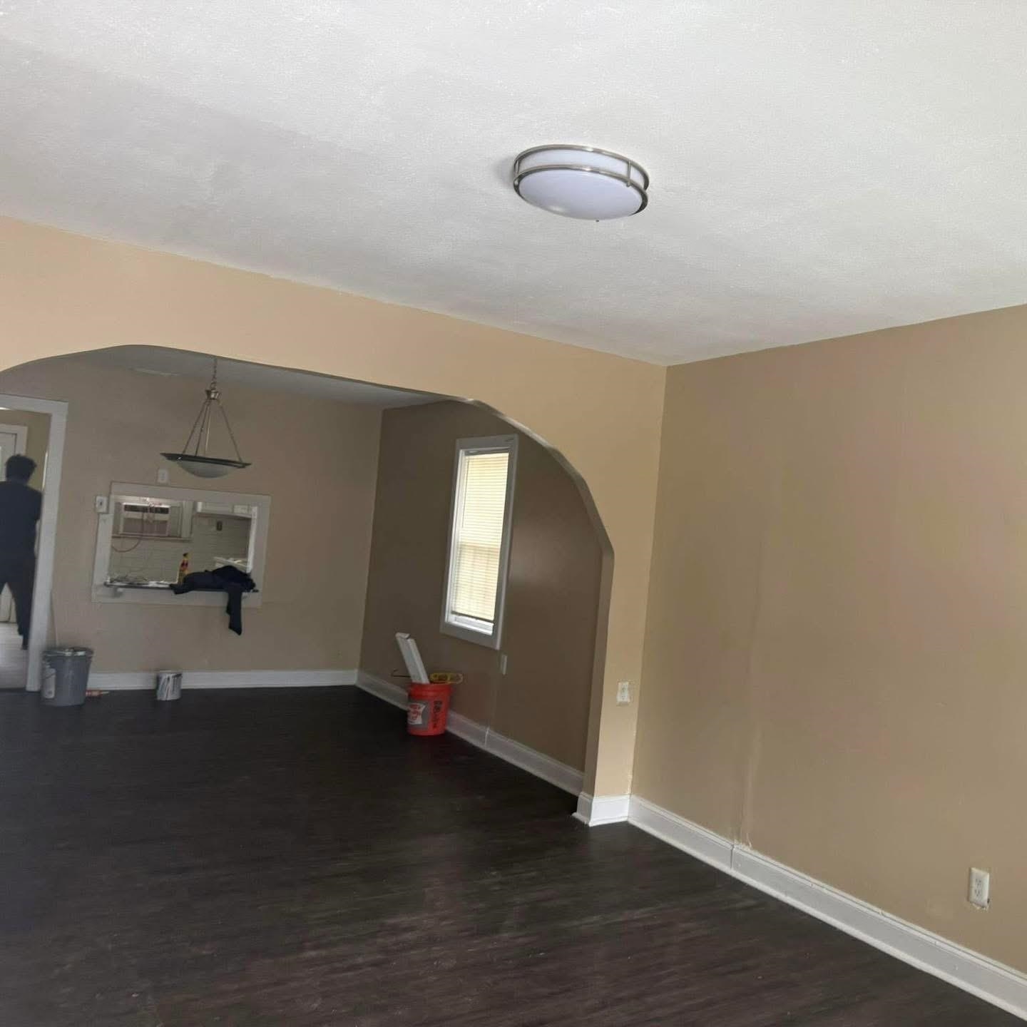 3596 Kendrick Road Memphis, TN 38108 - Photo 3 of 9 Empty room featuring arched walkways and dark wood-style flooring