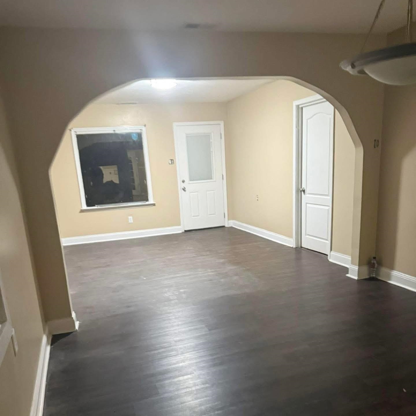 3596 Kendrick Road Memphis, TN 38108 - Photo 9 of 9 Additional living space featuring arched walkways and dark wood-type flooring