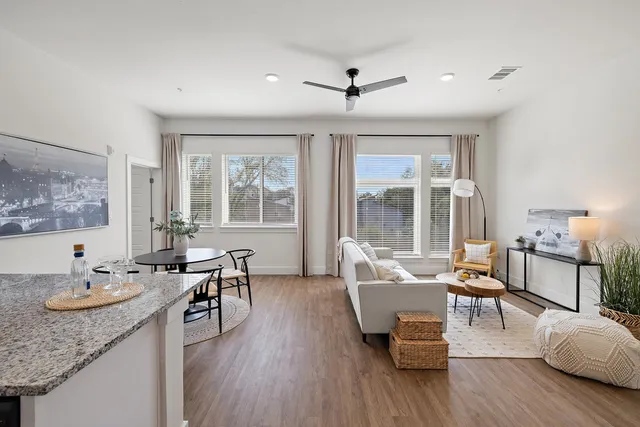 a living room with furniture and wooden floor