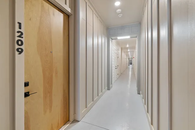 a view of a hallway with wooden floor