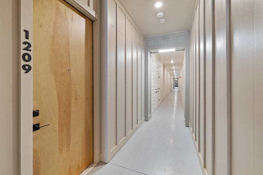 1811 Webberville Road, Unit 1209 Austin, TX 78721 - Photo 31 of 35 a view of a hallway with wooden floor