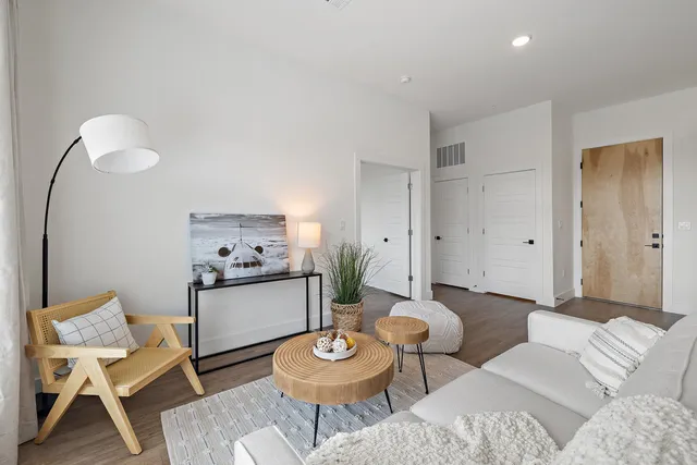a living room with furniture and a wooden floor