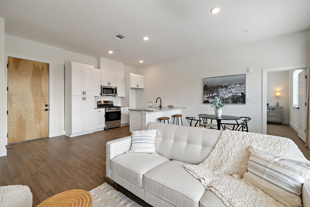1811 Webberville Road, Unit 1209 Austin, TX 78721 - Photo 5 of 35 a living room with furniture and kitchen view