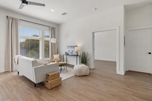 a living room with furniture and wooden floor